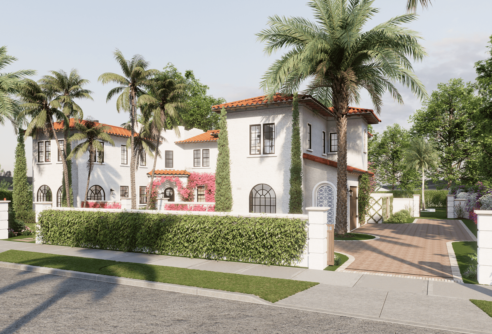 A Mediterranean-style house with white stucco walls, red-tiled roofs, and arched windows. The home is surrounded by palm trees, manicured hedges, and a paved driveway leading to a gated entrance, creating a luxurious and tropical atmosphere.