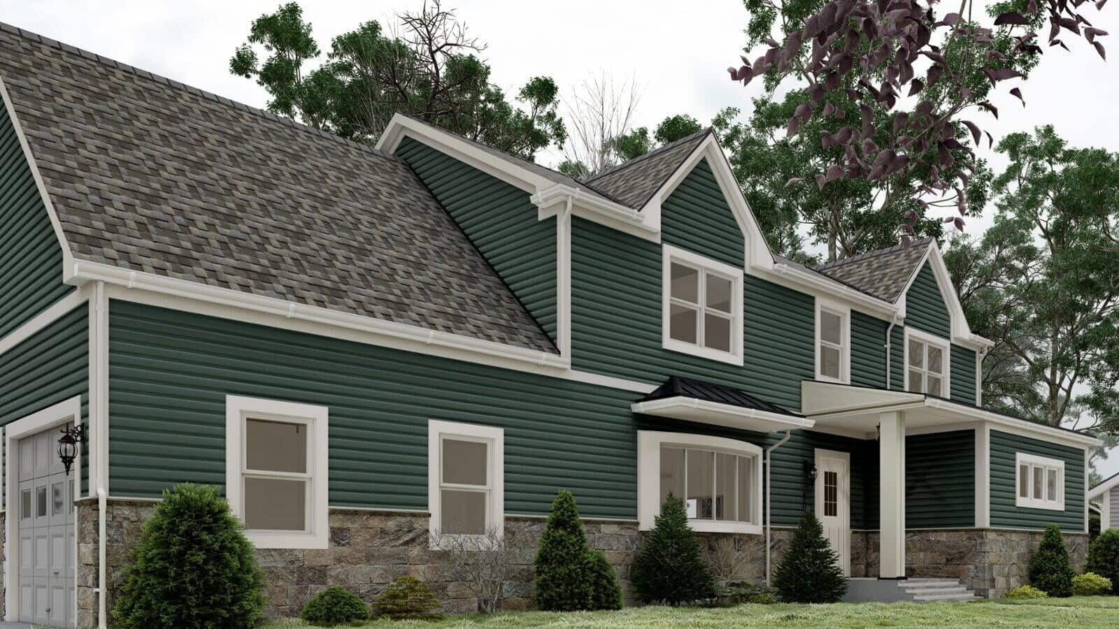 Green modular home with white trim and a stone foundation, showcasing a small front porch with steps and landscaped surroundings.