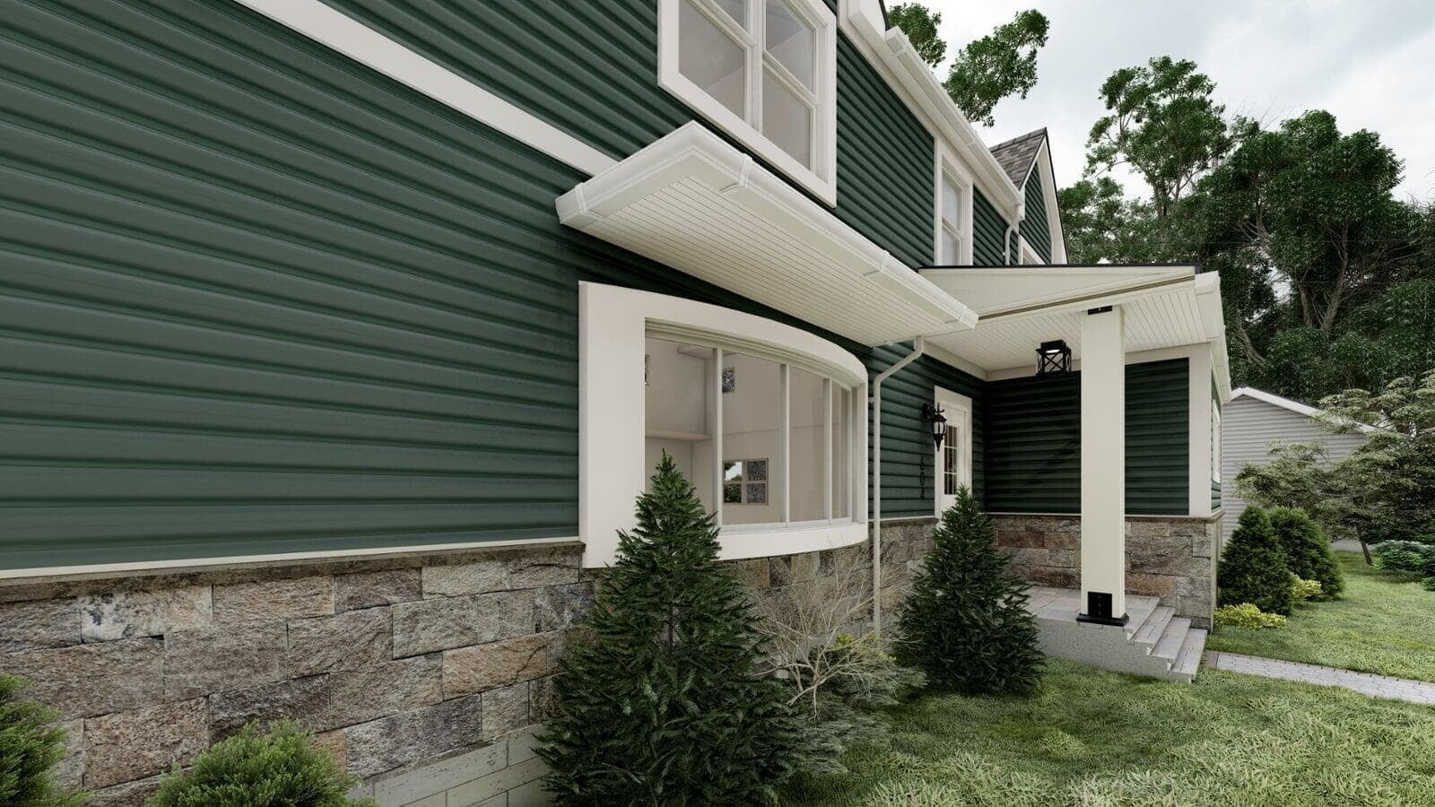Aerial perspective of a green modular home with white trim and a dark gray roof, highlighting the multiple gables and front landscaping.