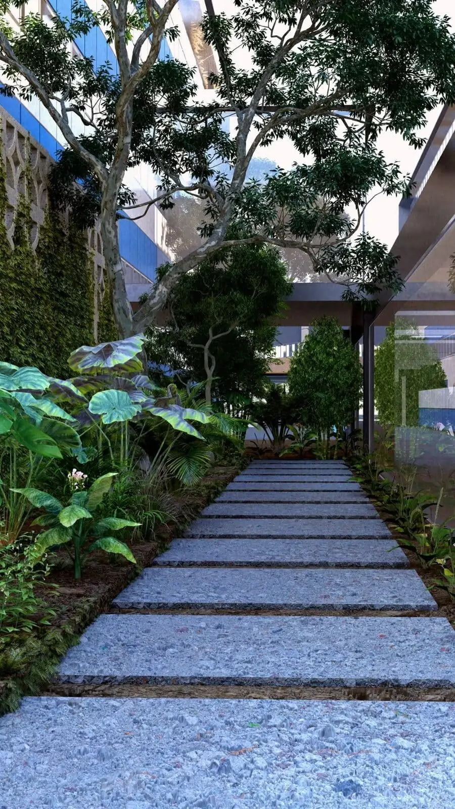 A photorealistic 3D rendering of a lush garden pathway in Tuluá, Valle del Cauca. The path is composed of large, rectangular stone slabs set in a bed of small gray stones. On either side, an abundance of tropical vegetation including large-leafed plants, shrubs, and towering trees creates a vibrant green canopy. The background features a modern building with geometric architecture, partially covered in climbing green vines, blending the structure seamlessly with the natural surroundings. This serene setting emphasizes a harmonious balance between urban and natural elements.