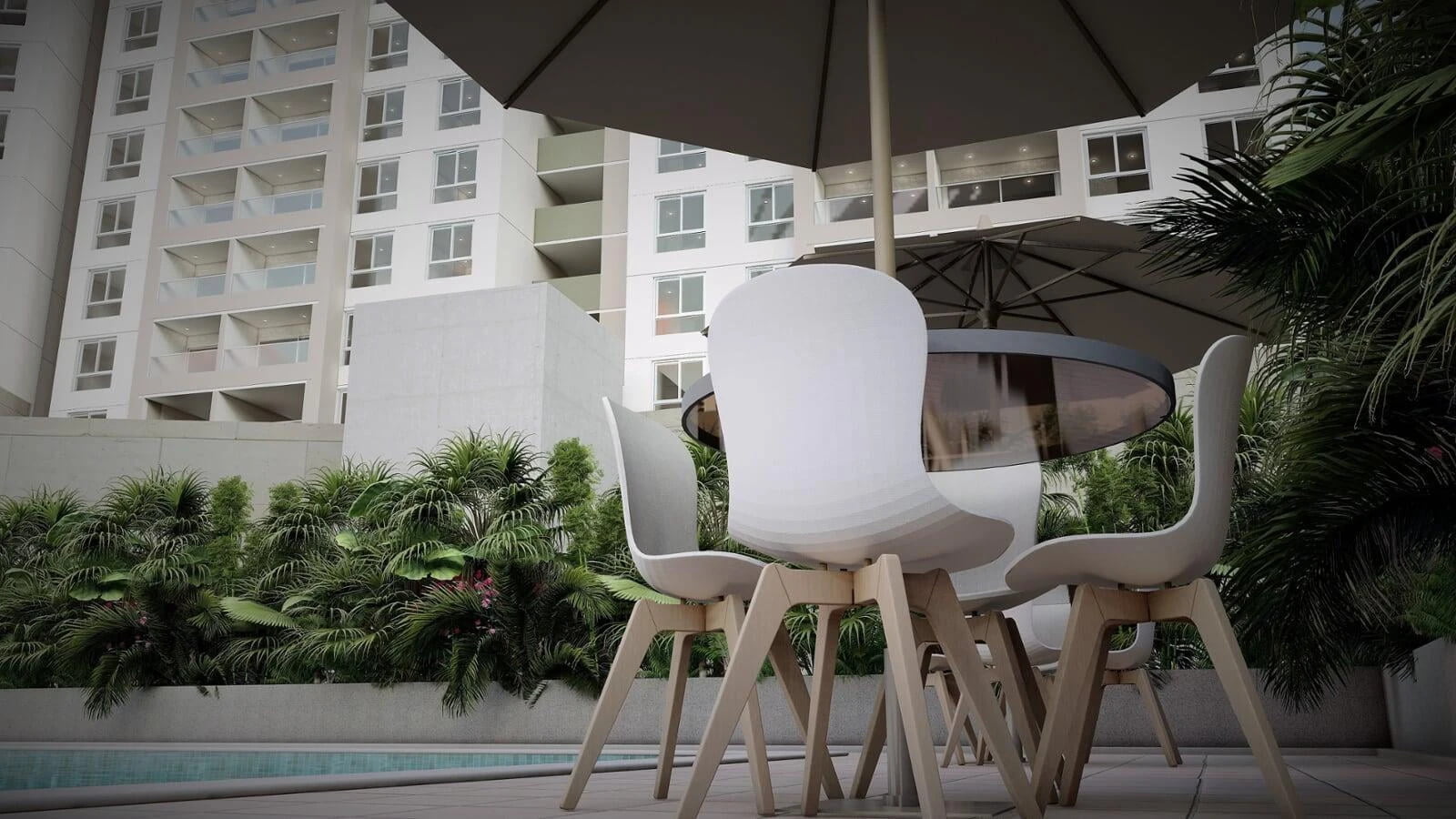 Modern outdoor seating area with a table, chairs, and a large umbrella, surrounded by lush greenery in a high-rise residential setting.