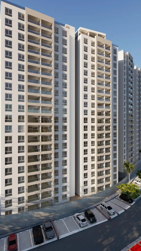 The image depicts a modern high-rise residential building, likely situated in an urban setting given the presence of multiple parked cars along a neatly paved street. The architecture features two prominent towers, connected at the base, characterized by numerous balconies and a predominantly white facade, which suggests a contemporary design. The surrounding area includes palm trees, indicating a possibly tropical or subtropical climate, which is common in regions like Cali, Colombia. The overall impression is of a well-planned, modern residential complex designed to accommodate a large number of residents in a city environment.